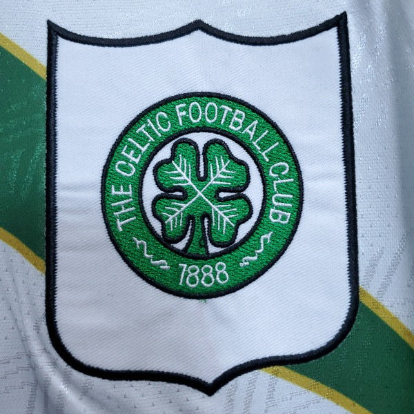 Celtic Football Club logo on a 93-95 Celtic away shirt  with green and yellow accents.