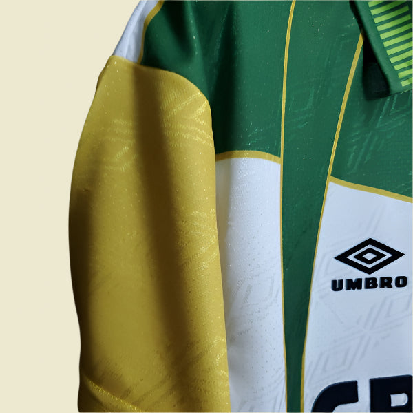 Close-up of a 93-95 Celtic away shirt  with a visible Umbro logo on a dark background