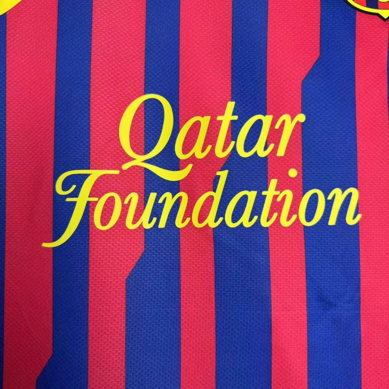 Text 'Qatar Foundation' on a red and blue striped Barcelona 11/12 home shirt