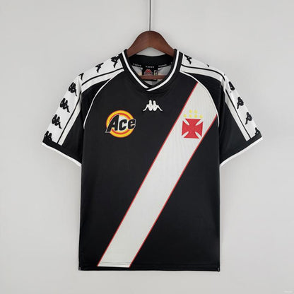 Black Vasco de gama 99 home shirt with white and red accents on a hanger against a gray background