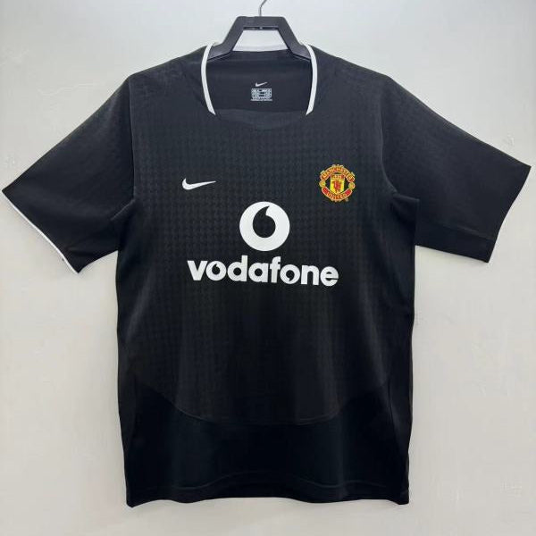 Black man United 03/04 away shirt with Vodafone and Nike logos on a white background