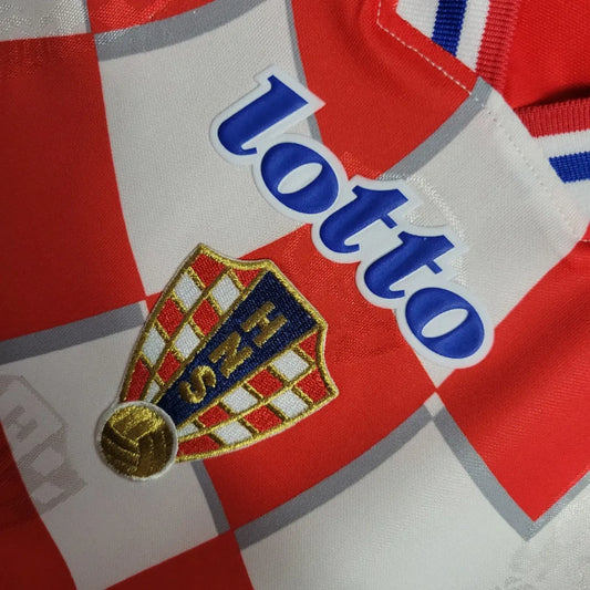 Close-up of a Croatia 1998 home shirt  with Lotto branding and a crest on a red and white background.