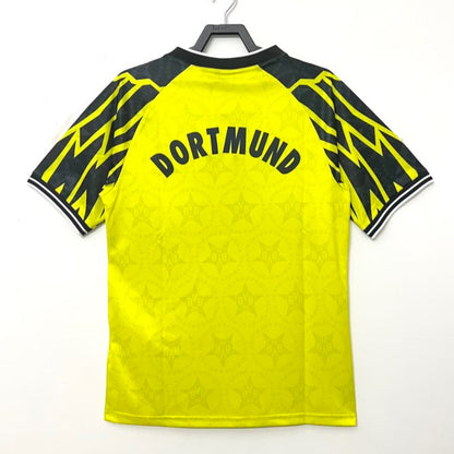 Yellow Dortmund 94/95 home shirt  with black accents and 'Dortmund' text on a white background