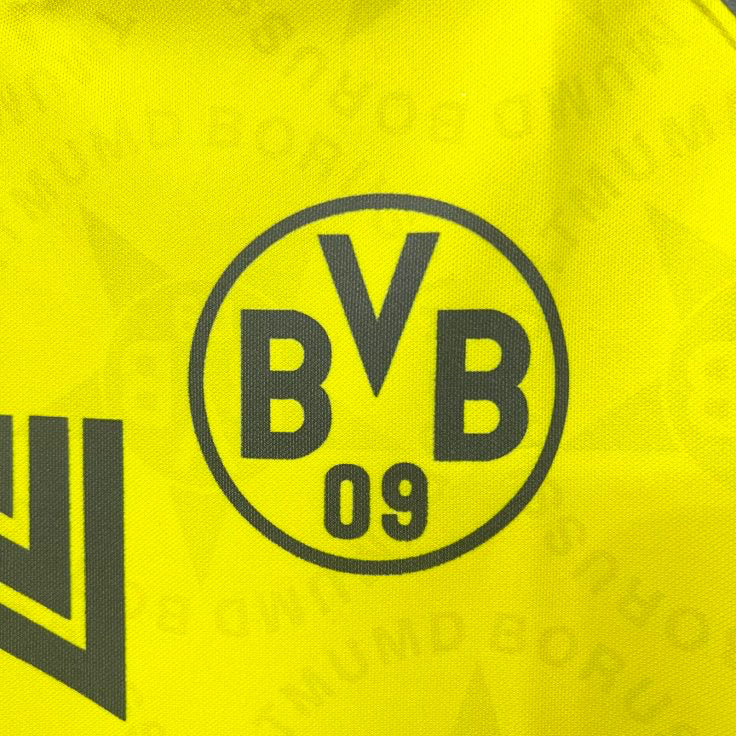 Close-up of a yellow Dortmund 94/95 home shirt  with BVB logo