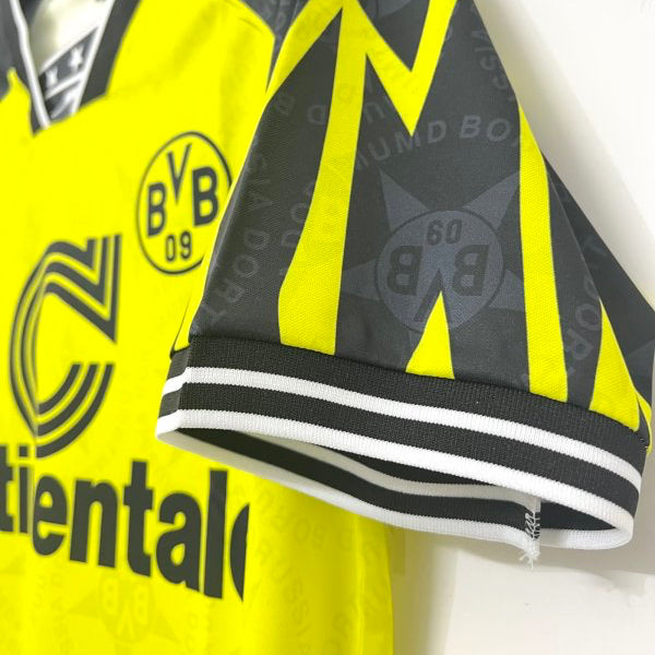 Yellow Dortmund 94/95 home shirt  with black and white accents featuring a logo on a white background