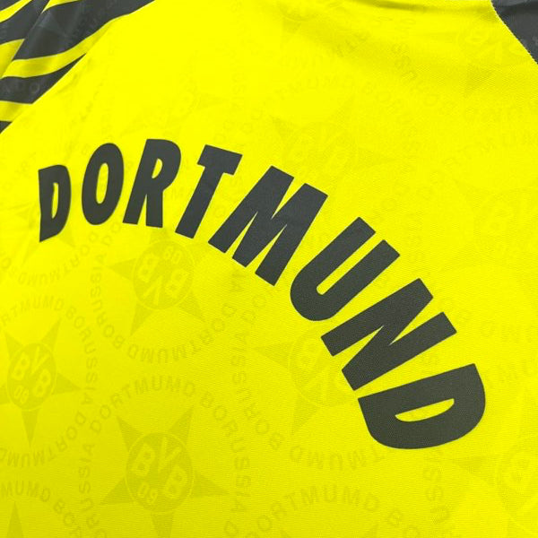 Yellow Dortmund 94/95 home shirt  with 'Dortmund' text and logo on a white background