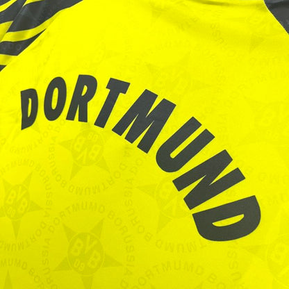 Yellow Dortmund 94/95 home shirt  with 'Dortmund' text and logo on a white background