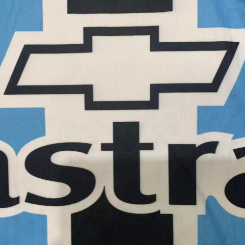 Chevrolet logo with 'astra' text on a blue and white Gremio 2000 home shirt 