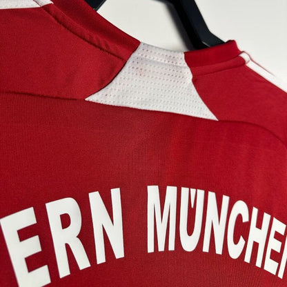 Bayern Munich 07/08 home shirt with 'BAYERN MUNCHEN' text on a hanger