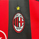 AC Milan jersey with logo and text on a red and black background