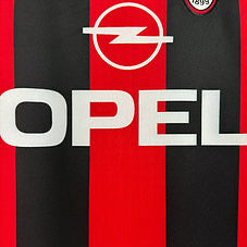Opel logo on a Ac Milan 00-02 home shirt  with red and black stripes