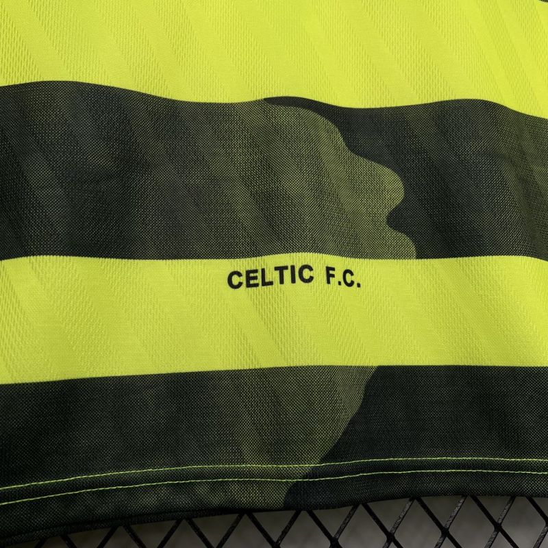 Green and yellow striped Celtic 96/97 away kit with 'CELTIC F.C.' text on a black background