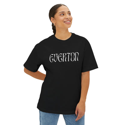 Person wearing a black t-shirt with 'Everton' printed on it against a white background