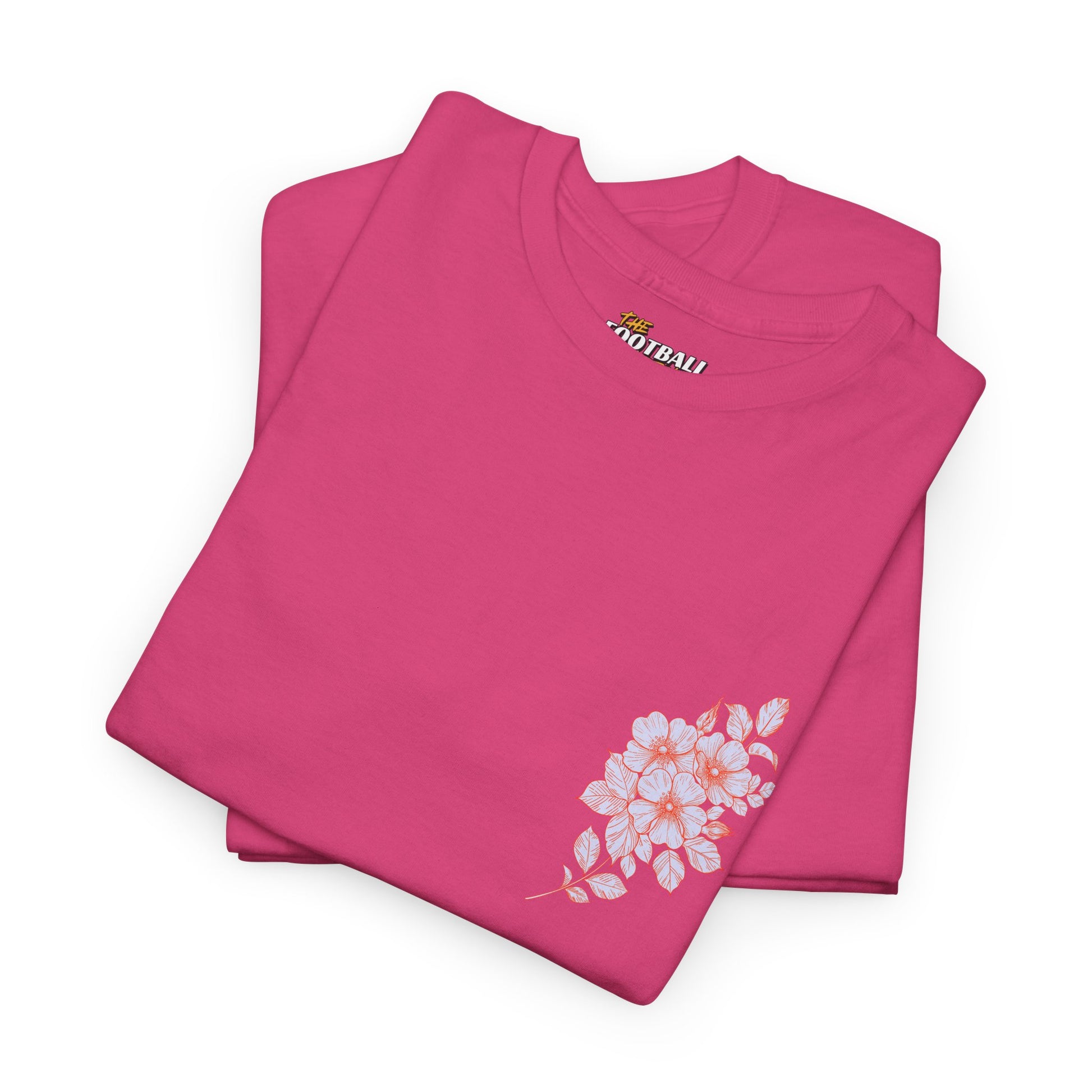 Folded pink t-shirt with floral design and visible brand logo on a white background