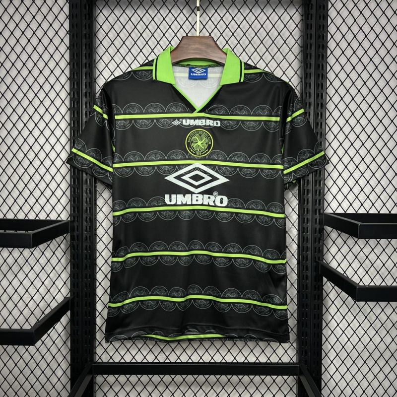 Black Celtic 98/99 away shirt with green accents hanging on a rack