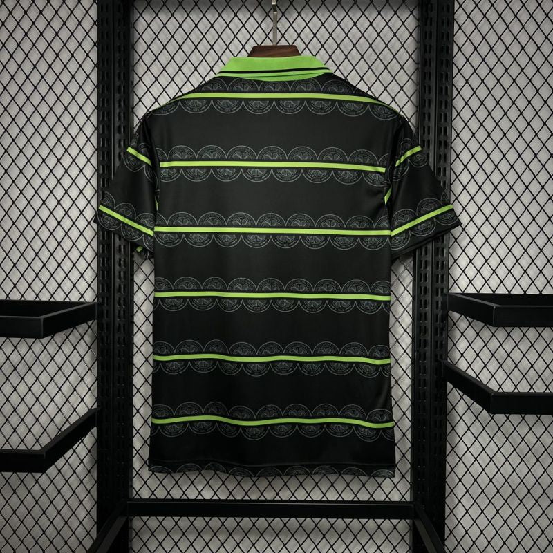 Black Celtic 98/99 away shirt shirt with green stripes hanging on a rack.
