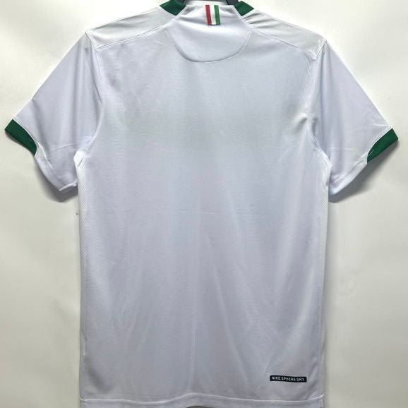 White Mexico 2006 away shirt with green accents on a hanger against a white background
