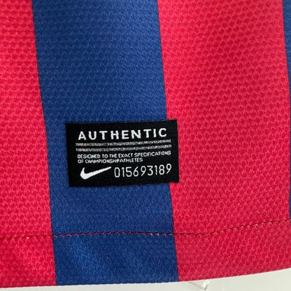 Close-up of a red and blue Barcelona 13/14 home shirt  with an authentic label.