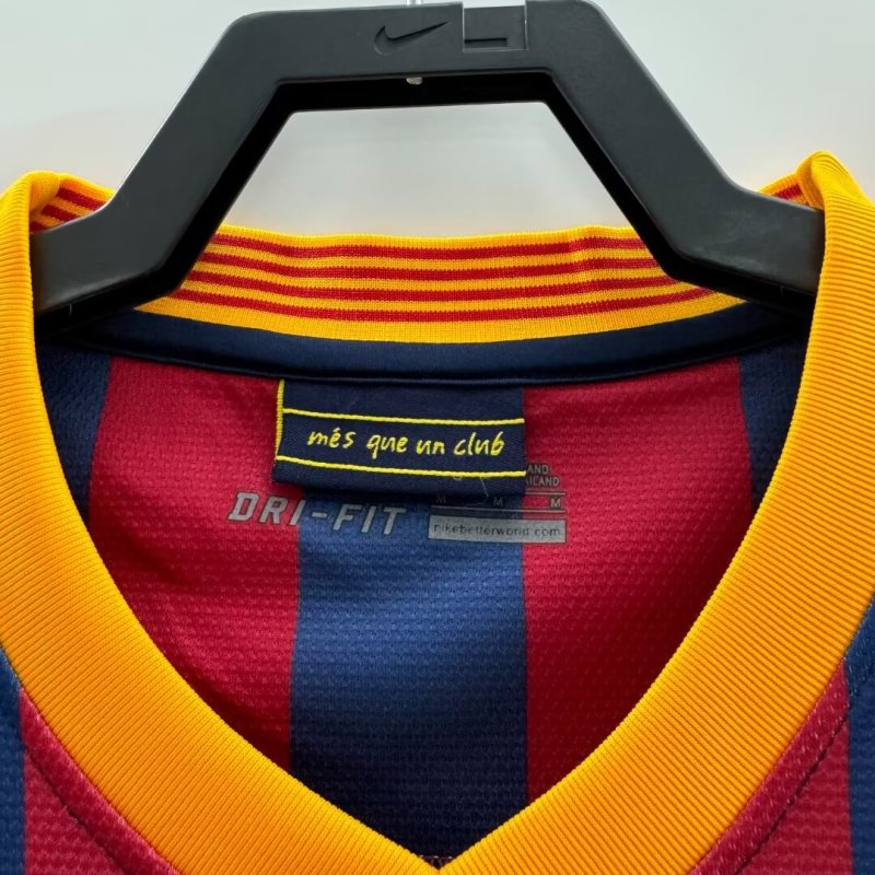 Red, yellow, and blue Barcelona 13/14 home shirt  with Nike logo on a hanger