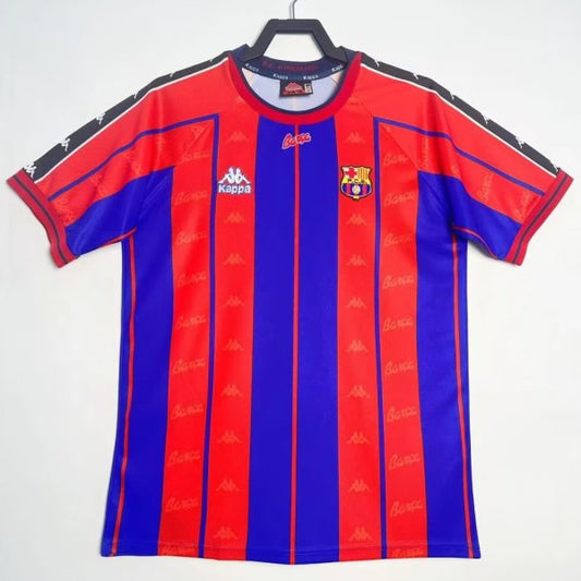 Red and blue Barcelona 97/98 home shirt with a logo on a hanger against a white background