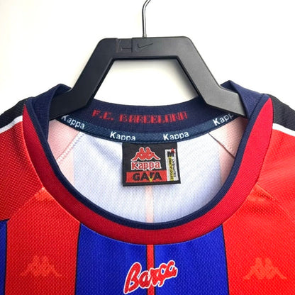 Barcelona 97/98 home shirt with visible brand logos on a hanger against a white background