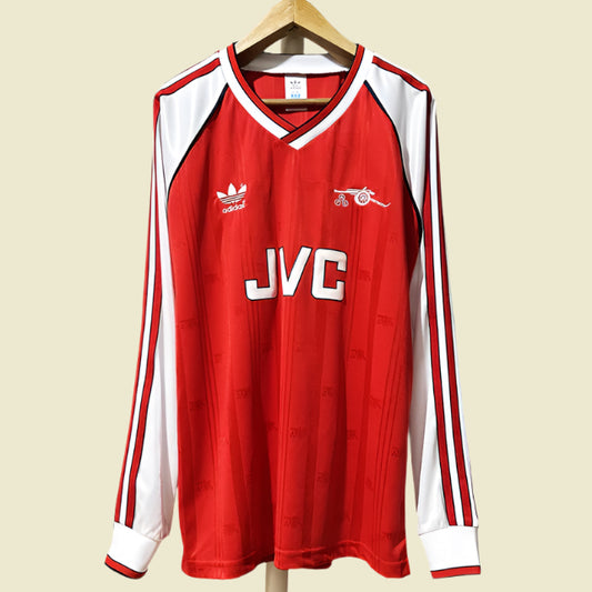 Red Arsenal 98-91 long sleeve home shirt with white accents on a hanger against a white background