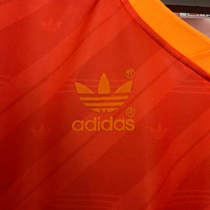 Close-up of Adidas logo on a red and orange Roma 92-94 home shirt