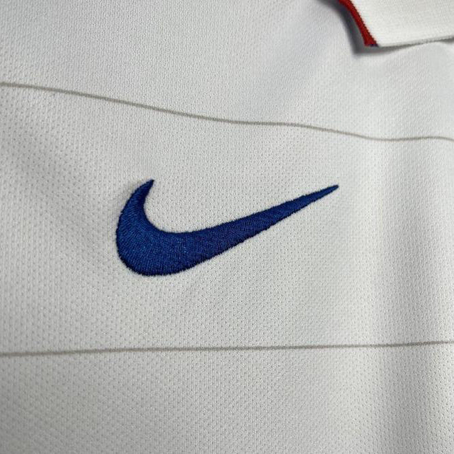 Close-up of a blue Nike logo on a white USA 2014 home shirt