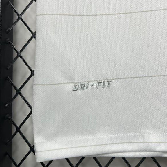 White USA 2014 home shirt with 'Dri-Fit' logo on a black grid background