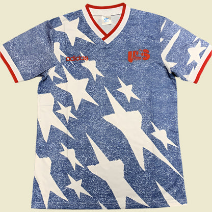 Blue USA 1994 away shirt with white star pattern and Adidas logo on a gray background
