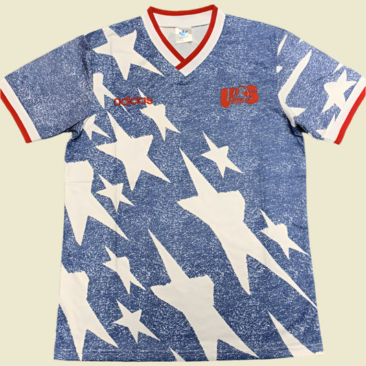 Blue USA 1994 away shirt with white star pattern and Adidas logo on a gray background