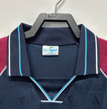 Navy blue West Ham 1999 iron maiden home shirt  with visible brand label on a hanger