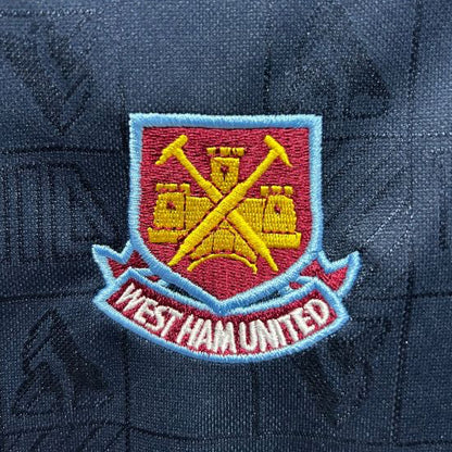 West Ham United logo on a dark blue West Ham 1999 iron maiden home shirt 