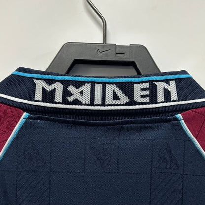 West Ham 1999 iron maiden home shirt  with 'MAIDEN' branding on a hanger against a white background