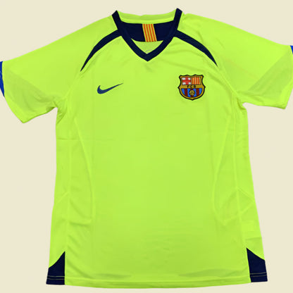 Bright green Barcelona 05/06 away shirt with Nike logo and Barcelona emblem on a gray background