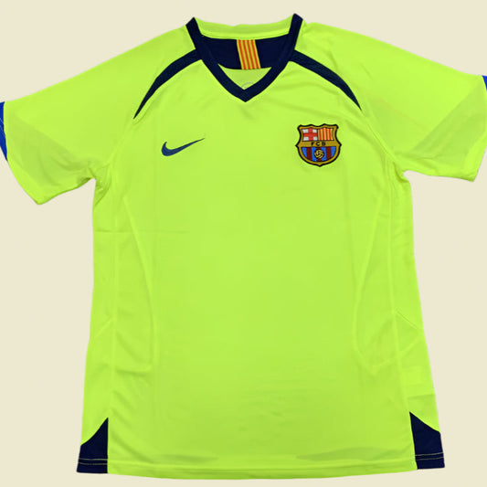 Bright green Barcelona 05/06 away shirt with Nike logo and Barcelona emblem on a gray background