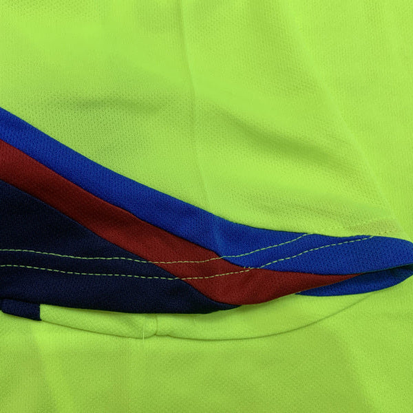 Close-up of a green Barcelona 05/06 away shirt  with blue and red detail
