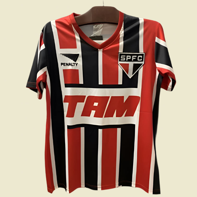 Red, black, and white striped São Paulo 93-94 away shirt with visible branding on a dark background
