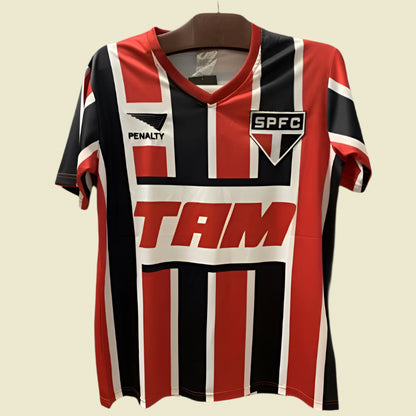 Red, black, and white striped São Paulo 93-94 away shirt with visible branding on a dark background