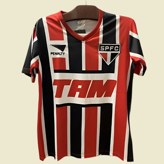 Red, black, and white striped São Paulo 93-94 away shirt with visible branding on a dark background