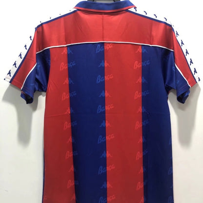 Red and blue Barcelona 92-95 home shirt with 'Barca' branding on a white background