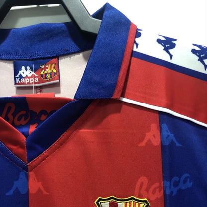 Red and blue Barcelona 92-95 home shirt with a prominent logo, featuring Kappa branding.