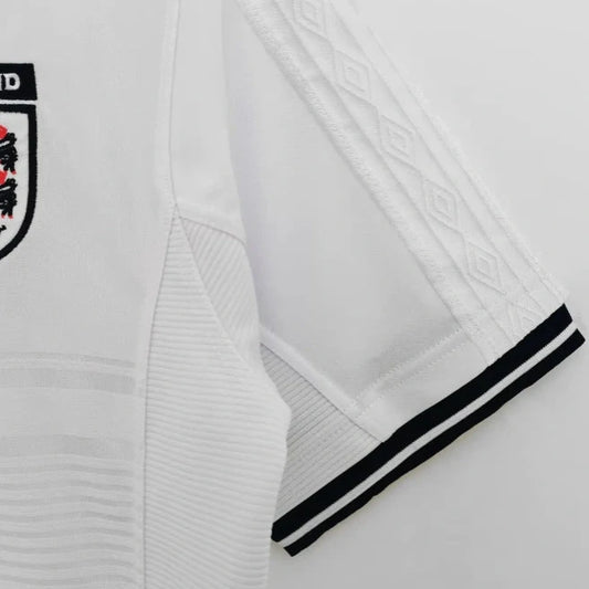 White England 2000 home shirt with black trim and England national team logo on a white background