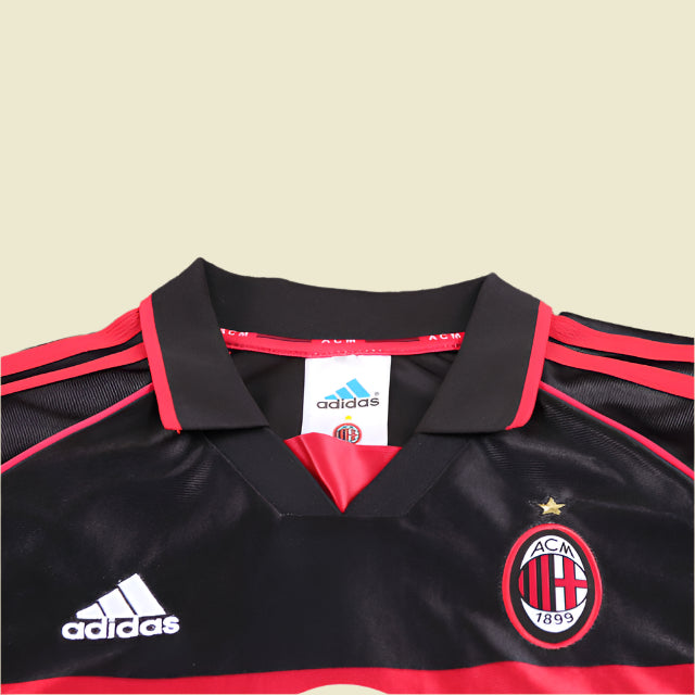 Black and red ac Milan 98/99 third kids kit  with Adidas logo on a textured gray background
