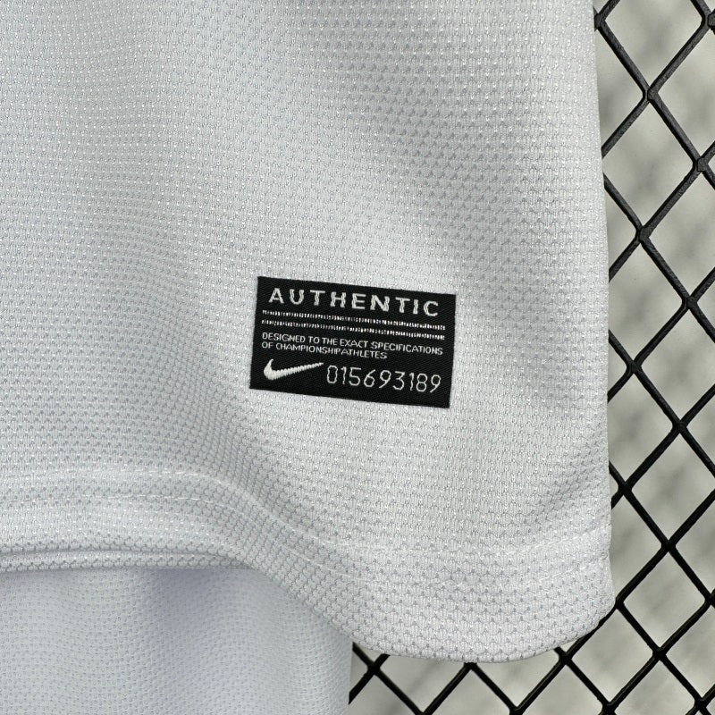 Santos 2012 centenary home kids kit with an 'Authentic' label on a black and white checkered background