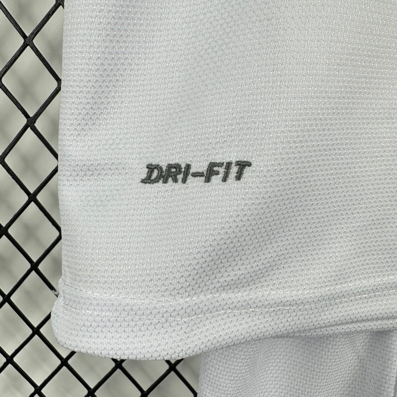 Santos 2012 centenary home kids kit with 'DRI-FIT' logo against a chain-link fence background