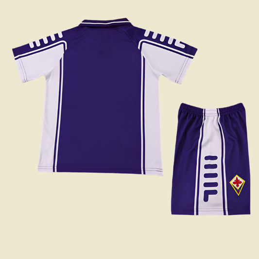 Purple and white Fiorentina 99/00 home kids kit  with shorts on a textured gray background