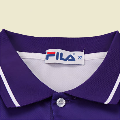 Close-up of a purple Fiorentina 99/00 home kids kit  with a Fila label on a textured gray background