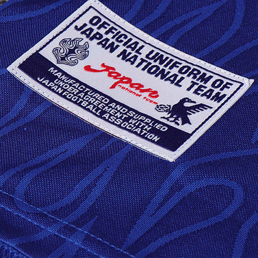 Blue Japan 1998 home kids kit with a logo label on a textured surface