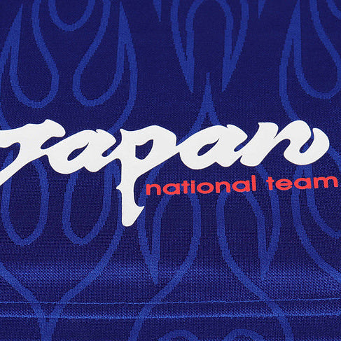 Text 'Japan national team' on a blue Japan 1998 home kids kit with flame pattern